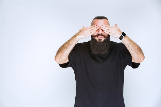 Man with beard looks sleepy and tired.  