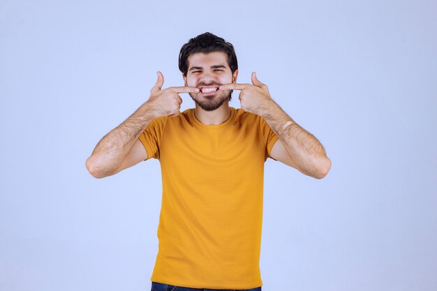 Man with beard pointing at her smile