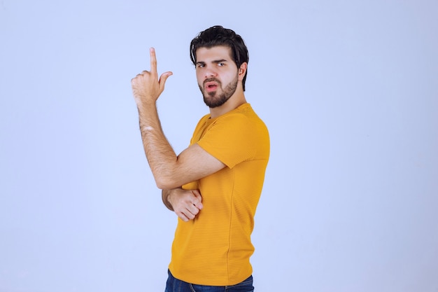 Man with beard pointing at something above