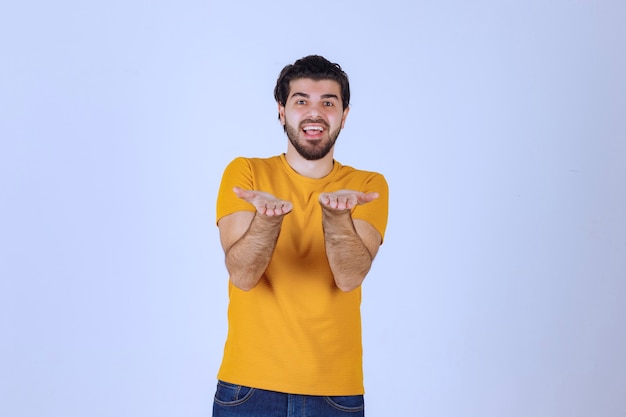 Man with beard presenting something in his open hand