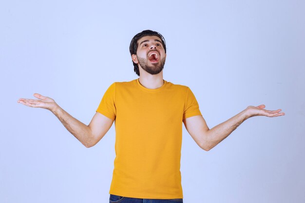 Man with beard presenting something in his open hand