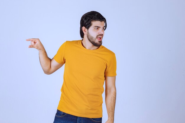 Man with beard showing estimated measures of an object