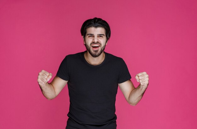 Man with beard showing his fists and feeling powerful