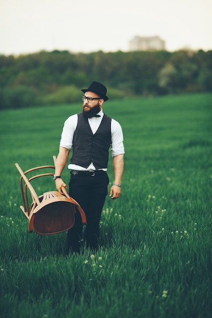 Man with a beard and sunglasses in the green field