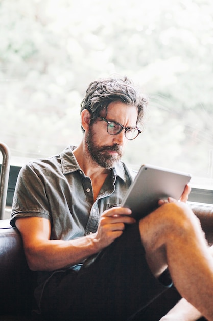 Man with beard using tablet