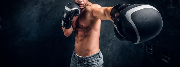 Free Photo man with beautifully muscular body is ready for fight, swowing his spectacular hits.