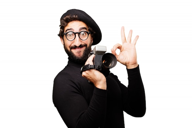 Man with a beret and glasses to watch with an old camcorder