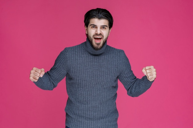 Man with black beard looks powerful and self confident.