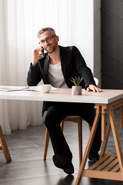 Man with black jacket talking on the phone long view