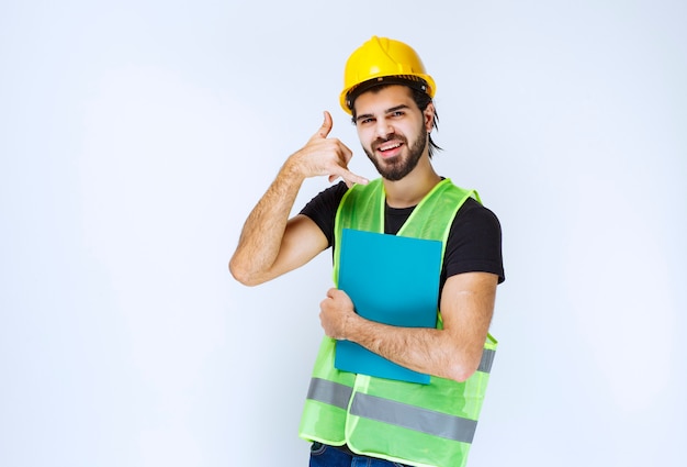 Man with a blue folder asking for a call.