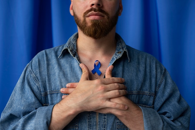 Free photo man with blue november ribbon