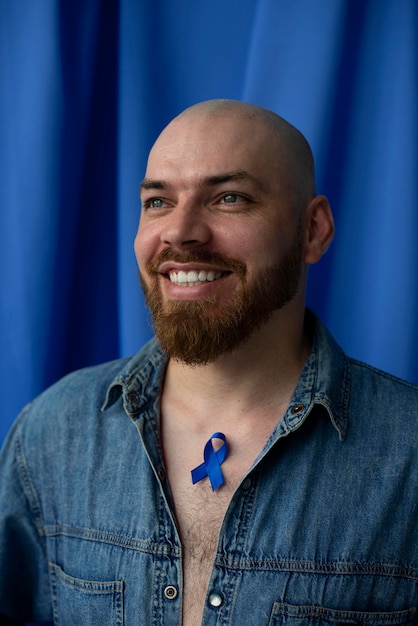 Free photo man with blue november ribbon