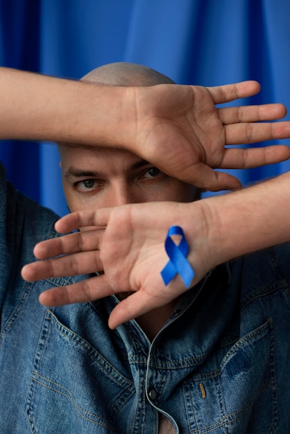 Free photo man with blue november ribbon