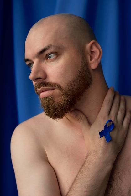 Free photo man with blue november ribbon