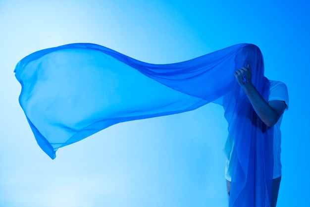 Man with blue scarf on his head