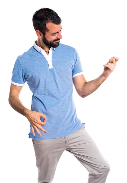 Man with blue shirt doing guitar gesture