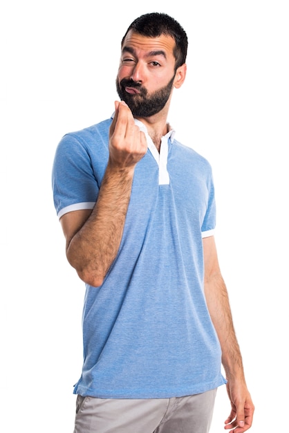 Man with blue shirt doing money gesture