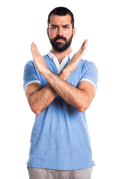 Man with blue shirt doing NO gesture