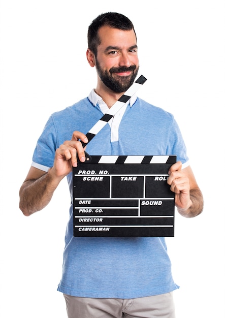 Man with blue shirt holding a clapperboard