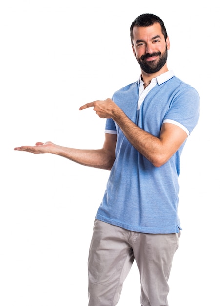 Man with blue shirt holding something