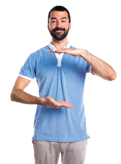 Man with blue shirt holding something