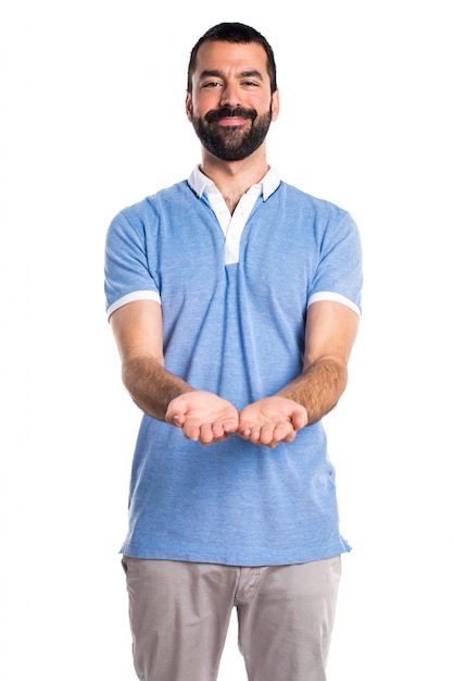 Man with blue shirt holding something