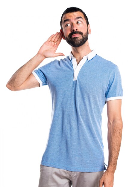 Man with blue shirt listening something