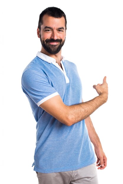 Man with blue shirt pointing back