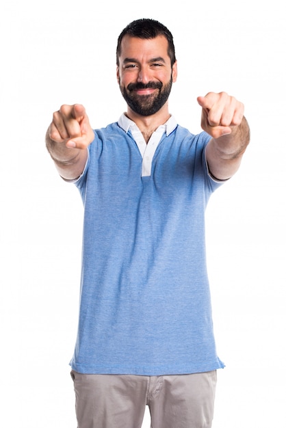 Man with blue shirt pointing to the front