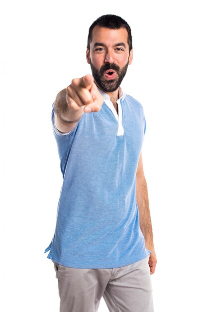 Man with blue shirt pointing to the front