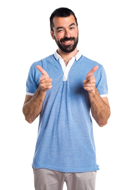 Man with blue shirt pointing to the front