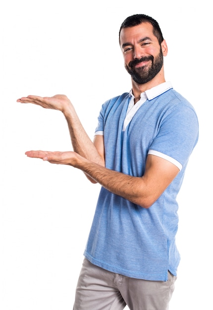 Man with blue shirt presenting something