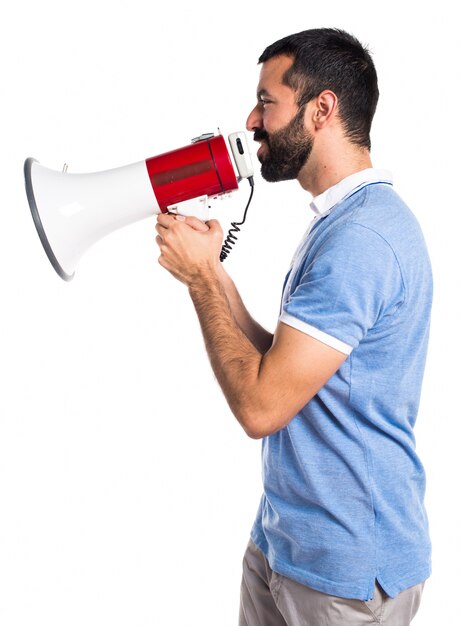 Man with blue shirt shouting by megaphone