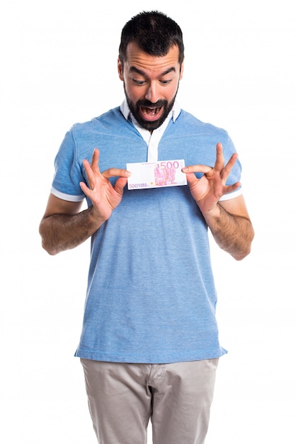 Man with blue shirt taking a lot of money