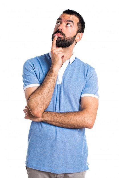 Man with blue shirt thinking