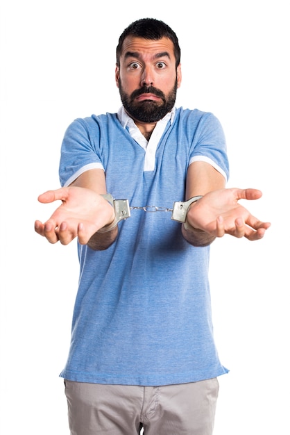 Man with blue shirt with handcuffs