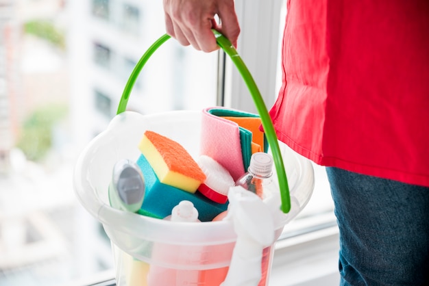 Man with bucket of cleaning products