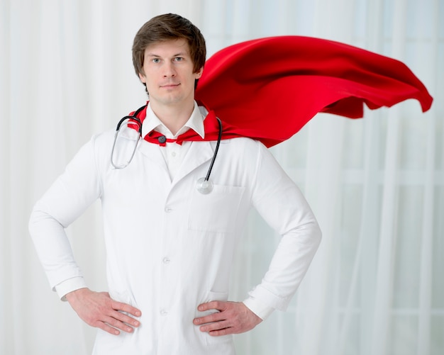 Free photo man with cape and stethoscope