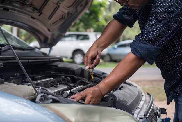 Man with checking car engine.