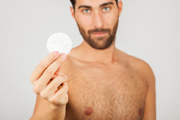 Man with cotton pad