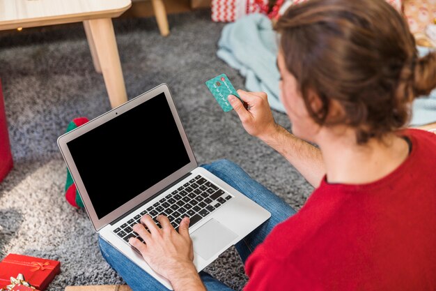 Man with credit card using laptop