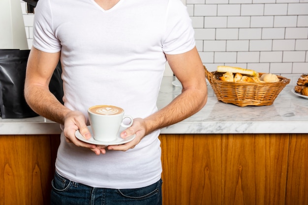Man with a cup of cappuccino in his hands
