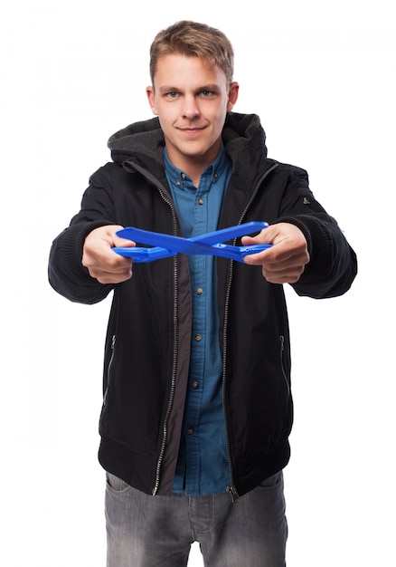 Free photo man with dark sweatshirt with blue scissors