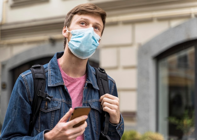 Man with face mask looking up