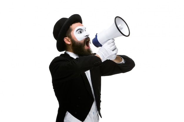 Free photo man with a face mime screaming into megaphone