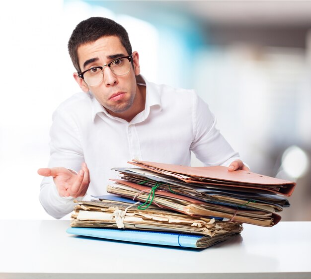 Man with face of not understanding with folders