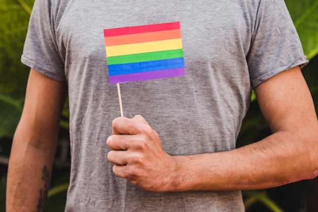 Free photo man with flag in lgbt colors in hand