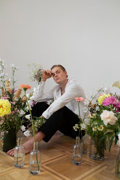 Man with flowers posing full shot