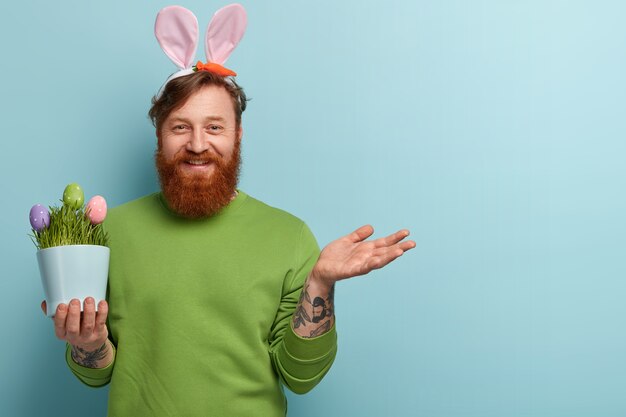 Man with ginger beard wearing colorful clothes and bunny ears