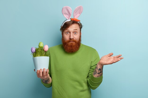 Man with ginger beard wearing colorful clothes and bunny ears